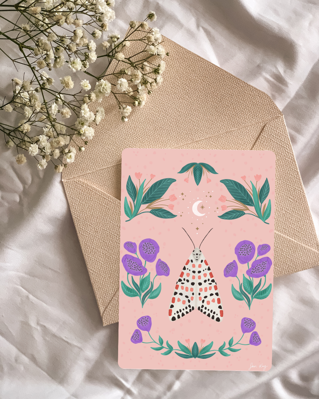 white moth with red, pink, and black spots on wings against a peachy background surrounded by large purple flowers with green leaves moon and stars and leafy plants with peach flowers